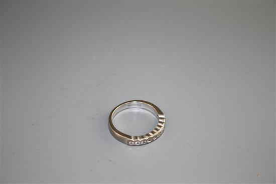 A modern 18ct white gold and ten stone diamond chip set half eternity ring, size M, gross weight 4.5 grams.